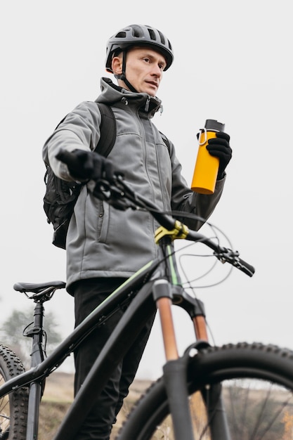 Front view of man riding a bike in mountain