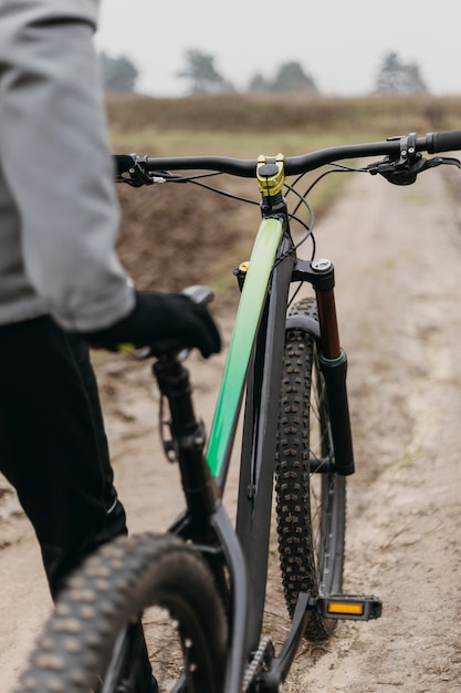 Free photo front view of man riding a bike in mountain