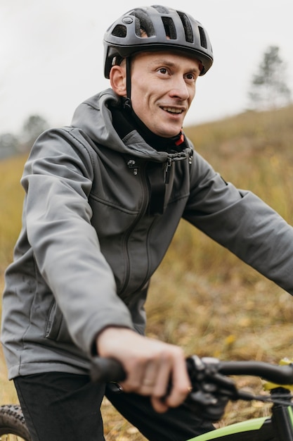 Front view of man riding a bike in mountain