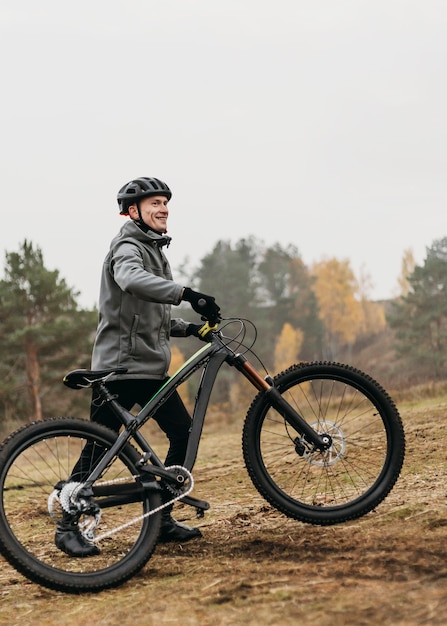 Front view of man riding a bike in mountain