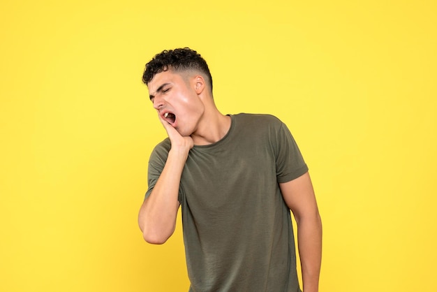 Front view of a man screams because he has a toothache
