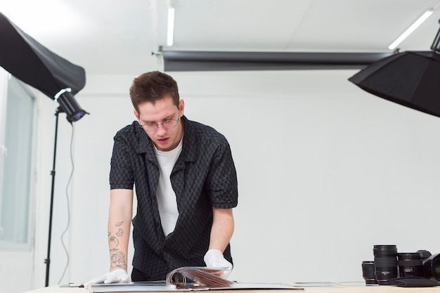 Front view man in shirt looking at a photo album