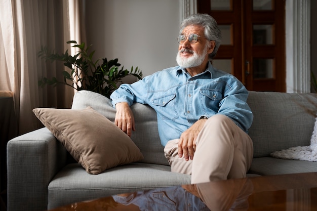 Free photo front view man sitting on couch