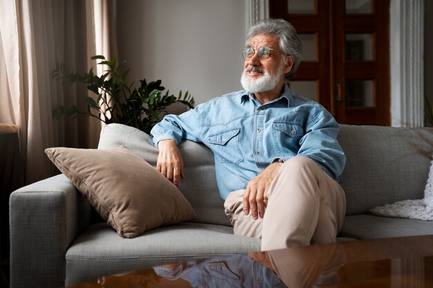 Front view man sitting on couch