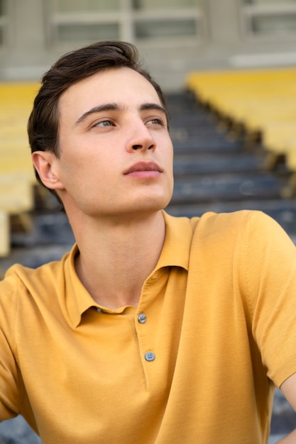 Free photo front view  man sitting in grandstands