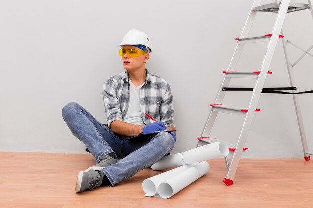 Front view of man sitting near stairs