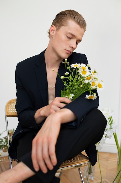 Front view man sitting with flowers