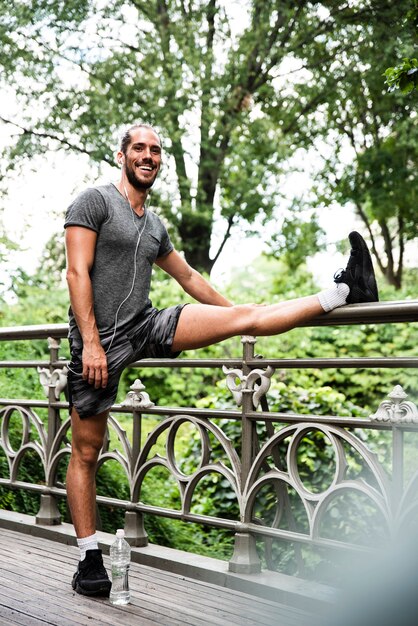 Front view of man stretching in park