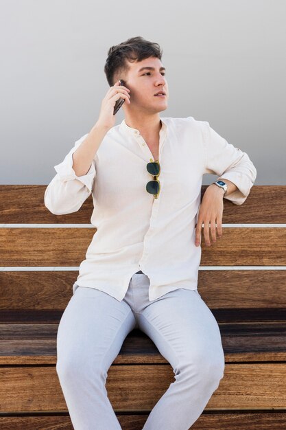 Front view of man talking on the phone outdoors