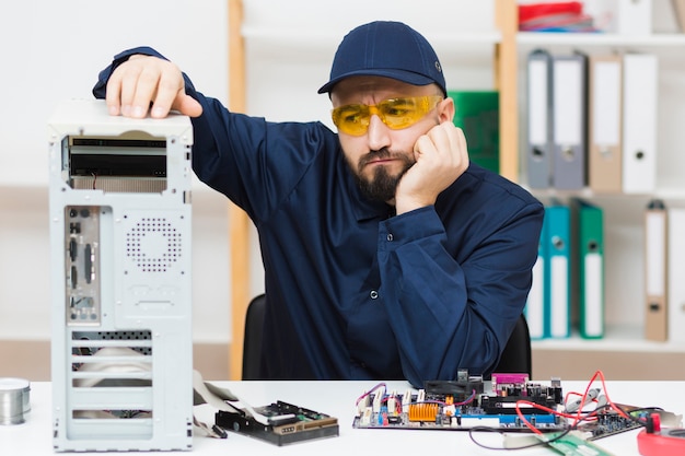 Front view man troubleshooting a computer