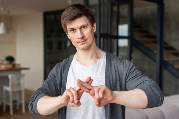 Free photo front view of man using sign language