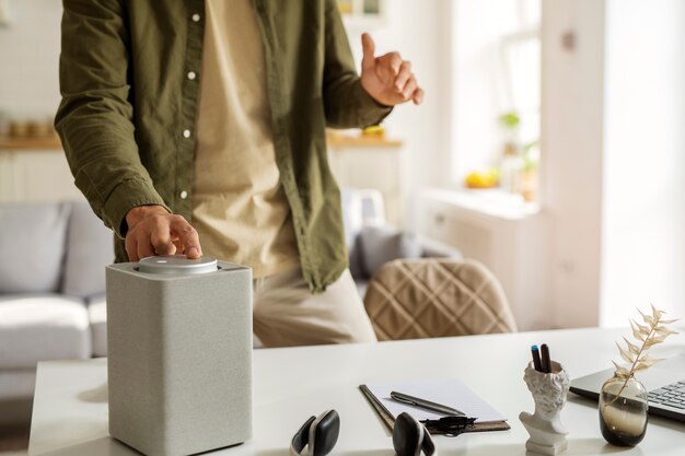 Front view man using smart speaker