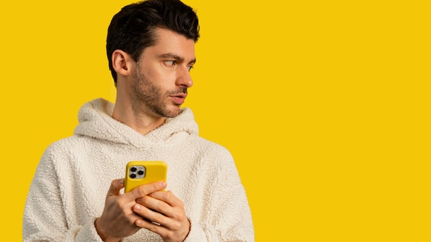 Free photo front view of man using smartphone with copy space