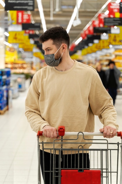 Front view man walking with cart