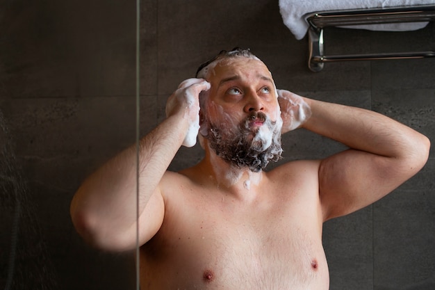 Front view man washing hair