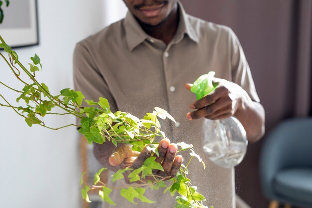 Front view man watering plants