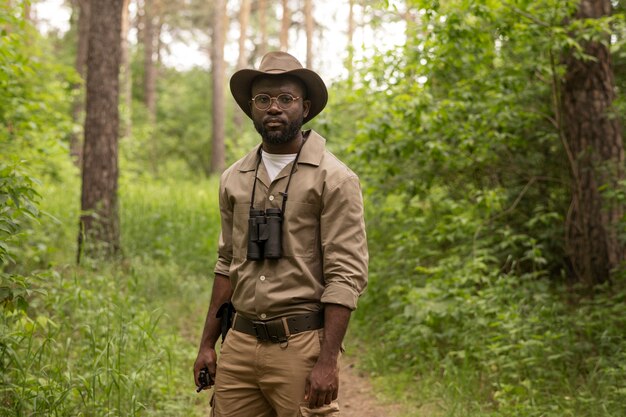 Front view man wearing binoculars