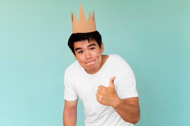 Front view of man wearing a crown with copy space