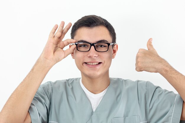 Front view of man wearing glasses and giving thumbs up