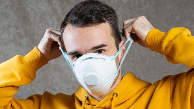 Front view of man wearing a medical mask on face for protection