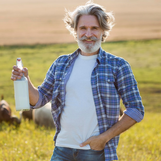 Front view man with bottle of goat milk