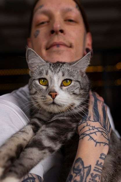 Front view man with cute cat at home