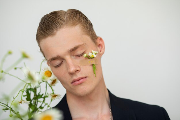 Free photo front view man with flower on cheek