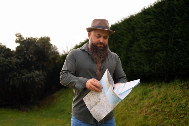 Front view man with map outdoors