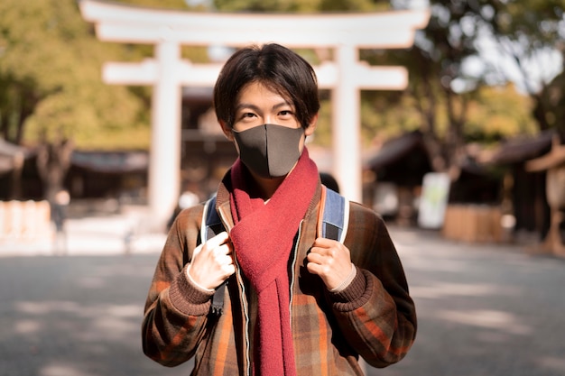 Front view of man with mask in the city