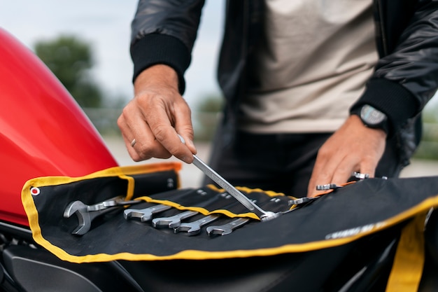 Foto gratuita uomo in vista anteriore con moto all'aperto