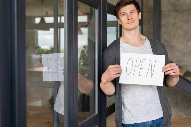 Free photo front view of man with open sign