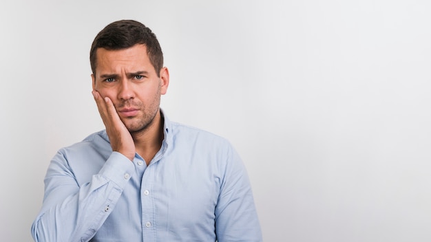 Free photo front view of man with palm on his cheek