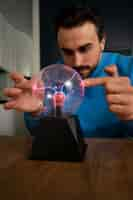 Free photo front view man with a plasma ball