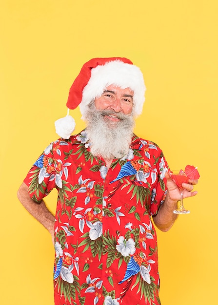 Front view of man with tropical shirt and christmas hat