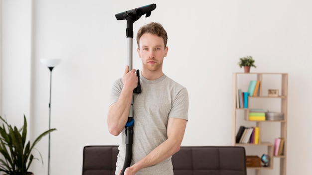 Free photo front view man with vacuum cleaner