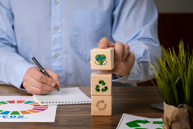 Free photo front view man with wooden blocks