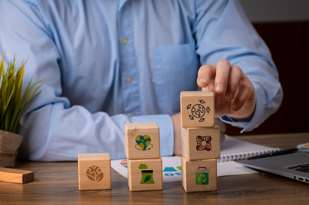 Free photo front view man with wooden blocks