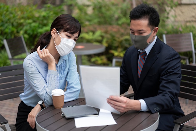 Free photo front view of man and woman discussing at table