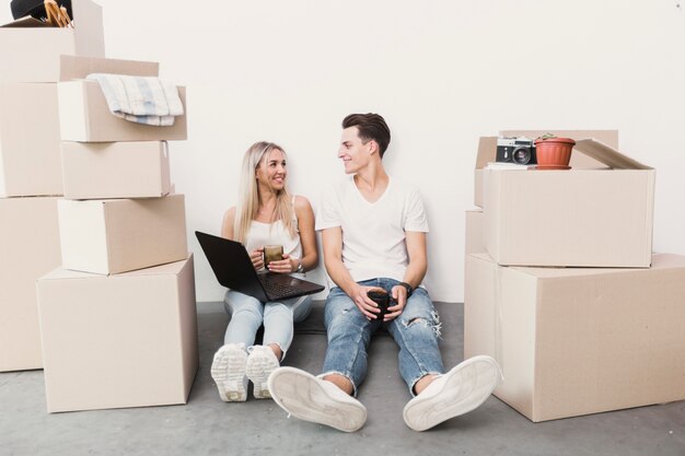 Front view man and woman sitting on the floor