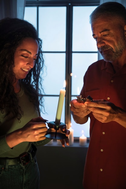 Front view man and woman with candle