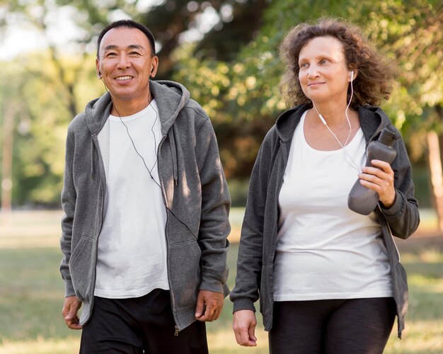 Front view man and woman with earphones