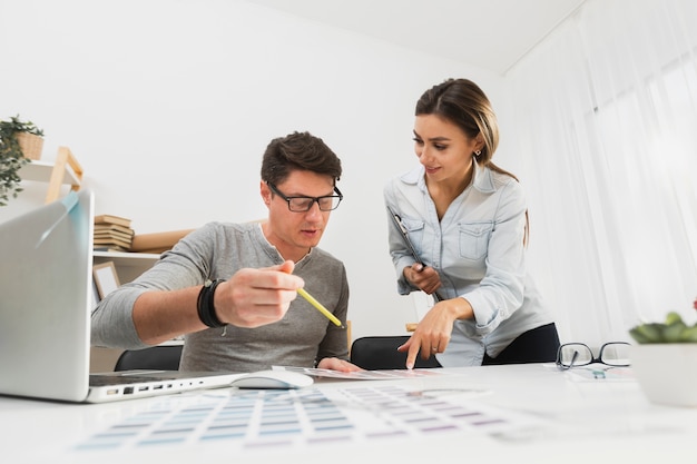 Front view man and woman working on  business papers