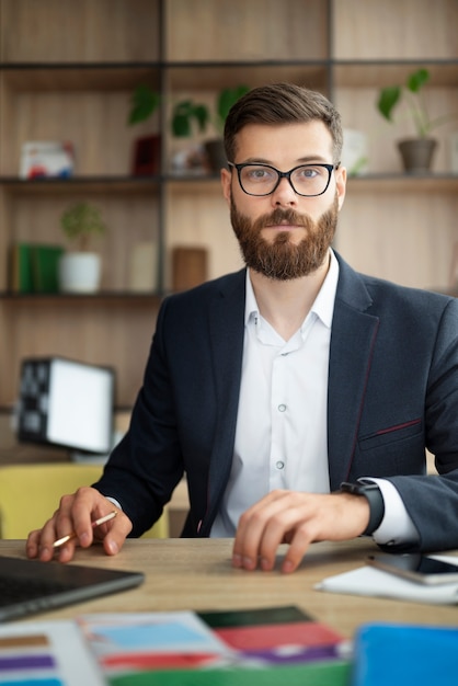 Front view man working at desk