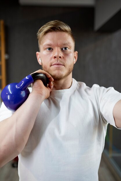 Front view man working out with kettlebell