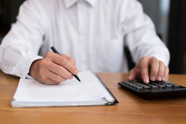 Front view man writing and calculating