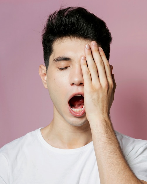 Free photo front view of man yawning