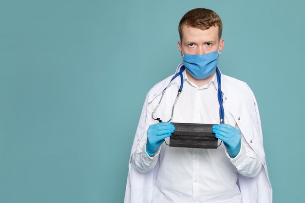 A front view man young in white medical suit and mask on the blue space