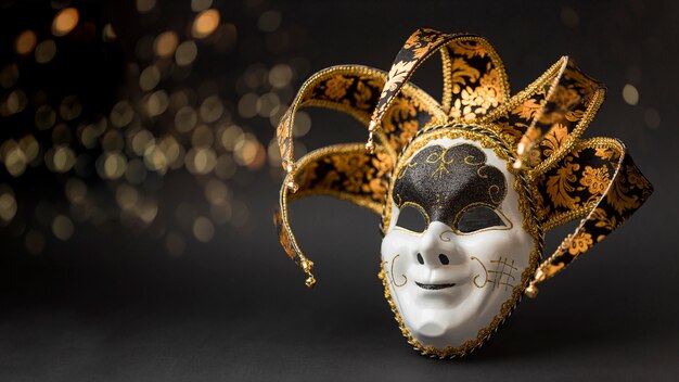 Front view of mask for carnival with glitter and copy space