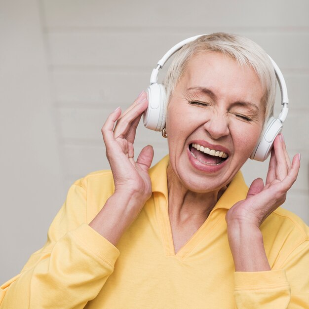 Front view mature woman listening to music