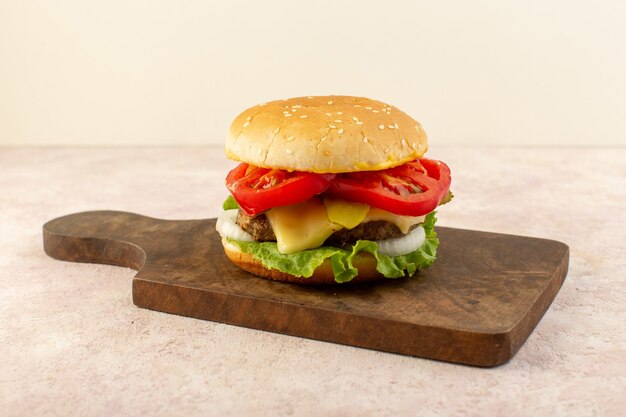 A front view meat burgers with vegetables cheese and green salad on the wooden table 